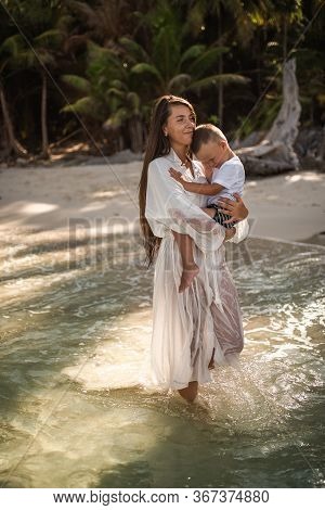 Happy Smile European Family Have Rest And Run On White Sand Beach