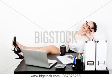 Attractive Lady In Strict Clothes And Glasses Cozily Threw Her Legs On Her Desk And Closed Her Eyes 