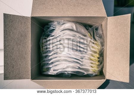 COVID-19 mask box of new N95 masks open PPE medical supplies for healthcare workers at hospital working in coronavirus pandemic.