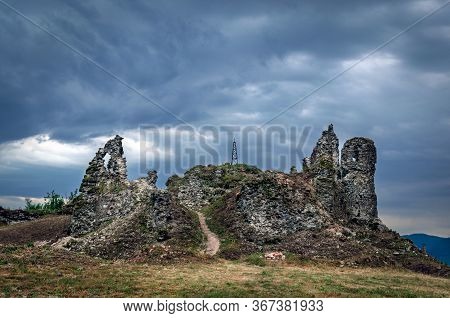 The Ruins Of An Old Castle In Khust, Transcarpathia Ukraine, Against A Background Of Thunderclouds.