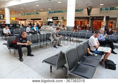 London, Uk - April 16, 2014: People Wait At London Heathrow Airport, Uk. Heathrow Is The Busiest Air