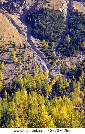 Waterfall In The Alps In The Province Of Morteratsch, Near The Famous Railway. Autumn Trees Over The