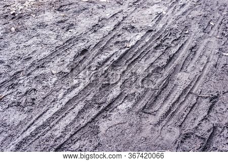 Boots And Bicycle Prints In The Mud After The Rain