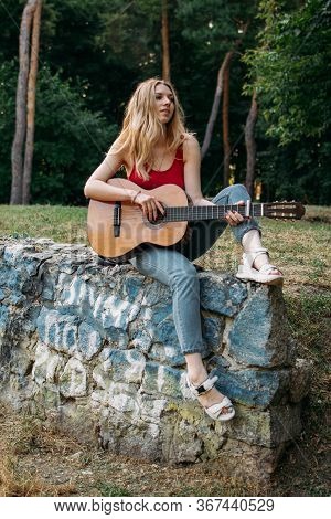 Learning To Play The Guitar. Beginner Guitar Lesson. Close-up Of Female Hand Playing Acoustic Guitar