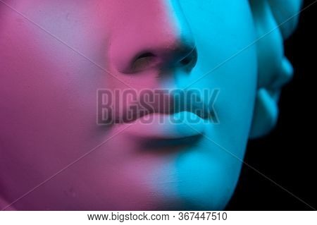 Colorful Gypsum Copy Of Ancient Statue Of Human Head For Artists On A Black Background. Close Up Vie