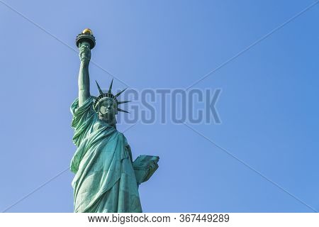 The Statue Of Liberty  With Blue Sky Background.