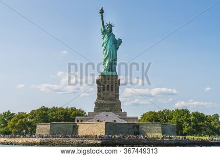 The Statue Of Liberty  With Blue Sky Background.