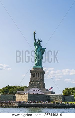 The Statue Of Liberty  With Blue Sky Background.