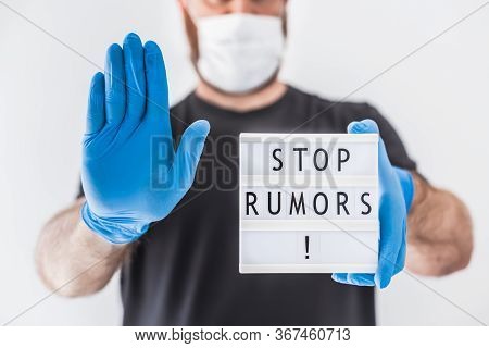Fake News Infodemics During Covid-19 Pandemic Concept. Man Wearing Protective Mask And Medical Glove
