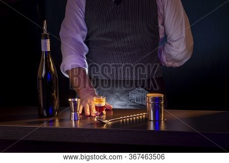 Bartender Serving Layered B52 Cocktail While Working In A Nightclub