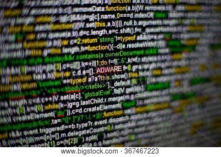 Macro Photo Of Computer Screen With Program Source Code And Highlighted Adware Inscription In The Mi