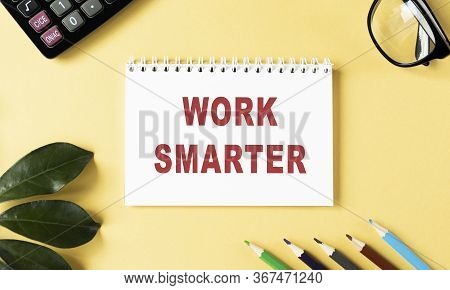 Work Smarter Text Written On A Notebook With Pencils And Graphs.