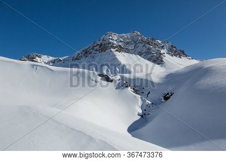 Peak Of Valbellahorn Mountain Near Arosa In Winter With Snow And Blue Sky