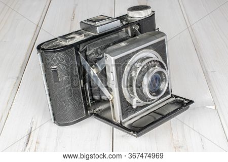 One Whole Vintage Camera On White Wood