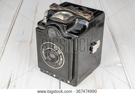 One Whole Vintage Camera On White Wood