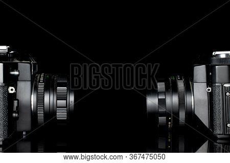 Group Of Two Whole Dark Vintage Camera Isolated On Black Glass