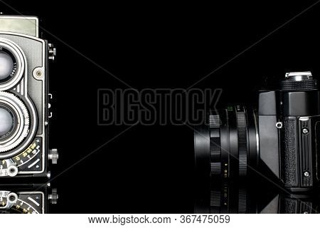 Group Of Two Whole Arranged Vintage Camera Isolated On Black Glass