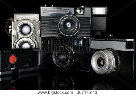 Group Of Five Whole Vintage Camera Isolated On Black Glass