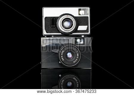 Group Of Two Whole Old Vintage Camera Isolated On Black Glass