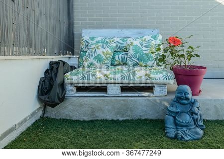 Beautiful Chillout Decoration Composed Of A Sofa Made With Wooden Pallets A Hibiscus And A Smiling B