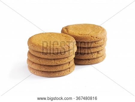 Close Up Plie Of Ginger Biscuits With More Behind   Isolated On A White Background