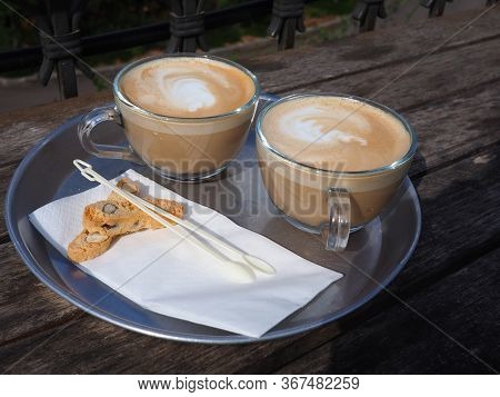 Cup Of Fresh Cappuccino Coffee Latte Served With Coockies On A Cafe Shop Wooden Table
