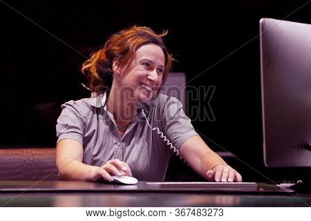 Woman Answers Customer Calls In A Call Center. The Secretary Answers The Phone And Talks With Client