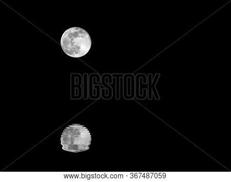Full Moon And The Reflection On The Water Of The Sea In The Dark Night