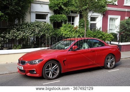 London, Uk - July 13, 2019: Red Flashy Bmw M2 Sports Car Parked In London. There Are 37.7 Million Ve