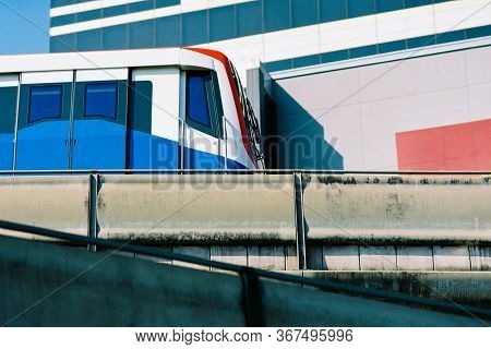 Modern Electric Railway Train (bts) Running On The Train Tracks Beside The Shopping Mall In The Big 