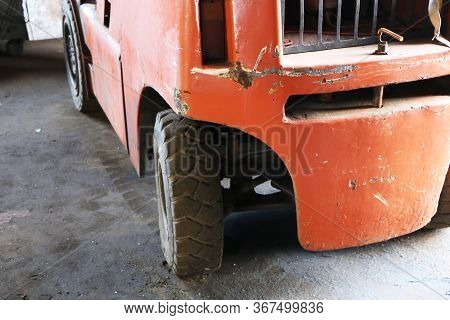 Car -old Forklift, Forklift, Stacker Truck, Warehouse Forklift. Old Car Under Repair In The Garage.