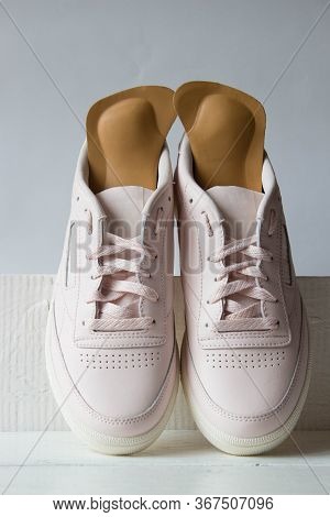 Pair Of Pink Running Shoes With Orthopedic Insoles. White Background.