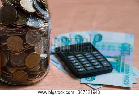 Glass Jar With Russian Manets, Calculator And Rubles