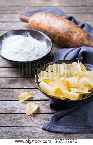 Brazilian Cuisine Food, Latin Snack. Yucca, Yuca, Cassava, Manioca Chips And Flour On A Table.