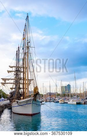 A Schooner Ship, Sailing Vessel With A Three Masted Rig, Docked In Port Inside A Shipyard/ Boatyard 