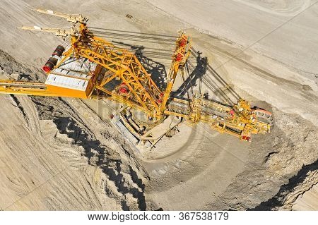 Top View Of A Bucket Wheel Excavator Mining Coal In An Open Pit Mine.