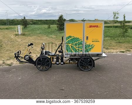 Almere, The Netherlands - May 22, 2020: Dhl Inner-city Electric Delivery Cargo Bike Parking On A Pub