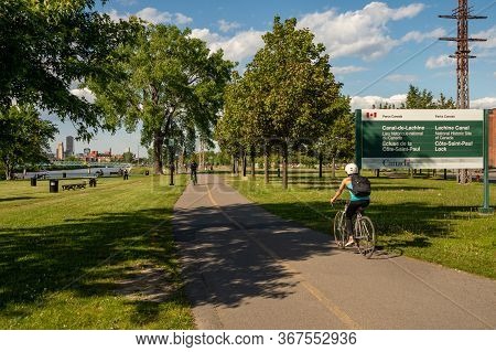 Montreal, Ca - 7 June 2019: Cyclist Enjoying A Warm And Sunny Spring Day Along The Lachine Canal.