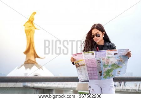 Macau - January 11, 2016: Young Female Tourist With Map Looking For A Way To Statue Of Kun Iam In Ma