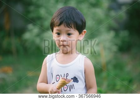 Asia Boy He Mouth Aftertaste From Eating Chocolate Ice Cream  Or Chocolate Dessert. A Sweet-toothed 