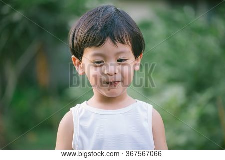 Asia Boy He Mouth Aftertaste From Eating Chocolate Ice Cream  Or Chocolate Dessert. A Sweet-toothed 
