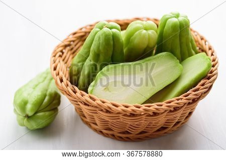 Chayote Squash Or Mirlition Squash In Basket On White Table, Organic Vegetables
