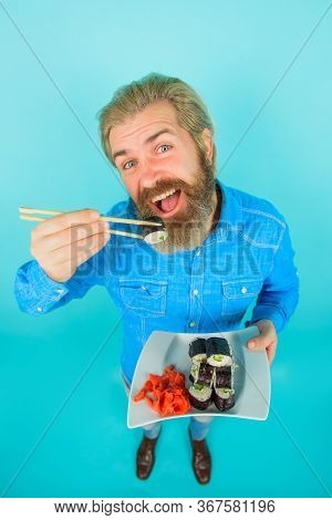Sushi. Japanese Food. Pickled Ginger. Man Eating Japanese Food. Bearded Man With Plate Of Sushiroll.