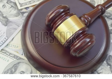 Judge Gavel And Money On Brown Wooden Table. Many Hundred Dollar Bills Under Judge Malice On Court D