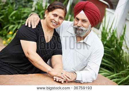 Happy Smiling indian sikh adult people couple outdoors
