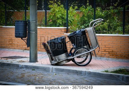 Sweeper Cart With Broom, Standing On The Sidewalk