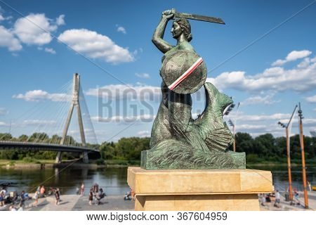 The Warsaw Mermaid called Syrenka on the Vistula River bank in Warszawa, Poland