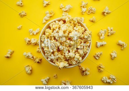 Bowl With Popcorn On Yellow Background. Top View. Entetainement Concept