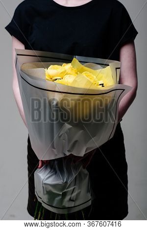 Bouquet Of Flowers In Transparent Package In The Hands Of A Woman Florist. Rosa Spray Catalina, Rham