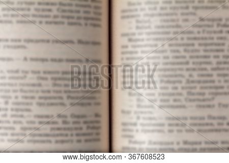 Open Book With Blurry Text. The Concept Of Journalism, Censorship And Historical Propaganda